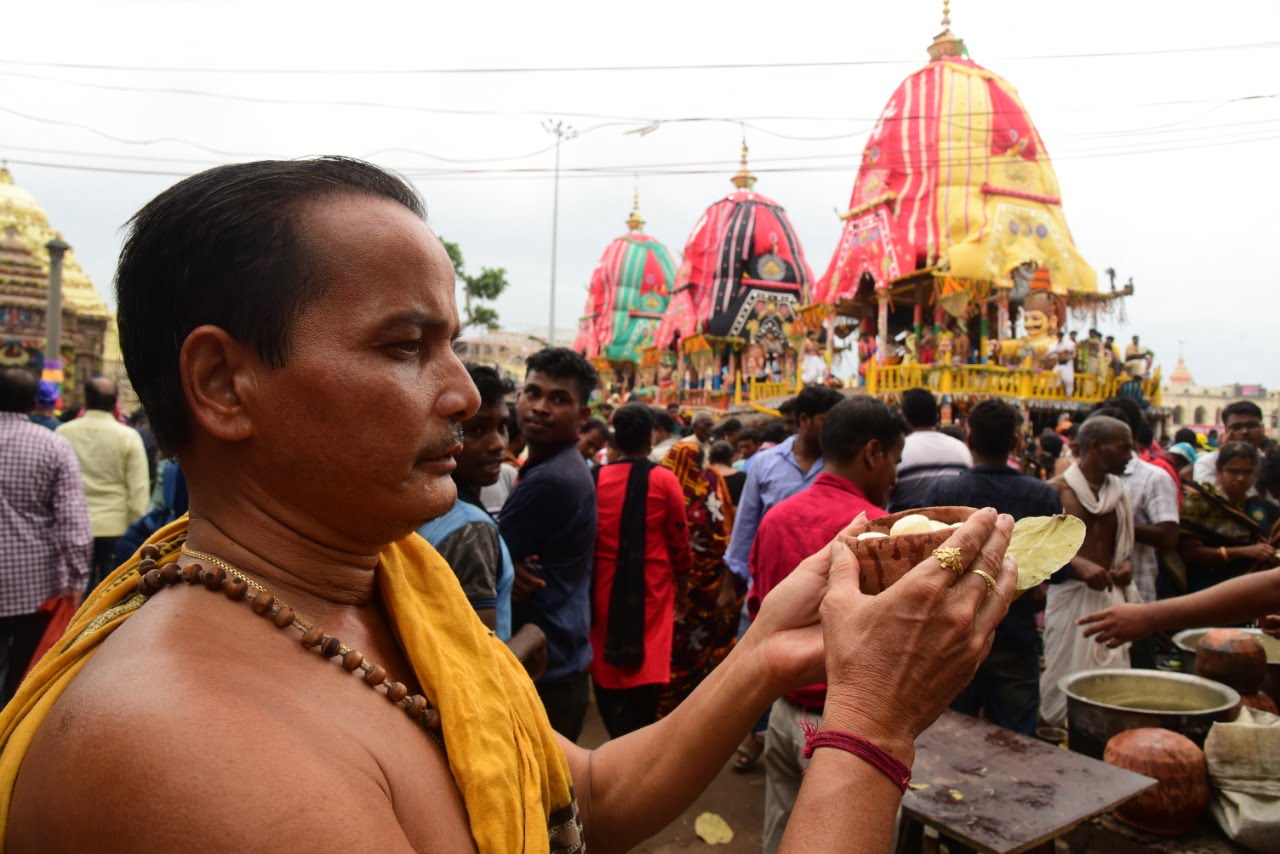 DIVINE DESSERT: A devotee offering Rasagola to Lord Jagannath, Lord Balabhadra and Goddess Subhadra as part of Niladri Bije festivities in Puri on Monday. Rasagola is an integral part of the celebration as it is believed that Lord Jagannath offered the sweet to pacify his wife Goddess Laxmi, who was upset over Her husband going on a vacation without her. OB Photograph