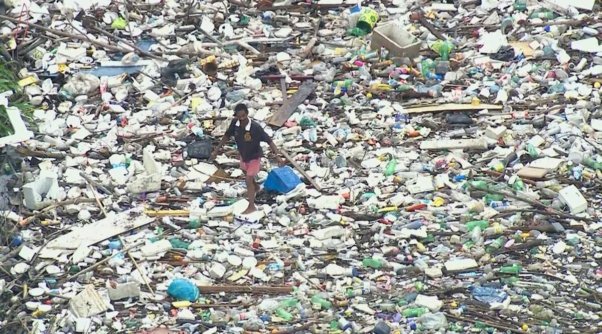 viral video man walking on sea of garbage in Brazil